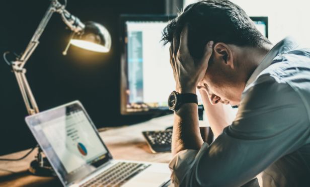 worried small business owner laptop shutterstock