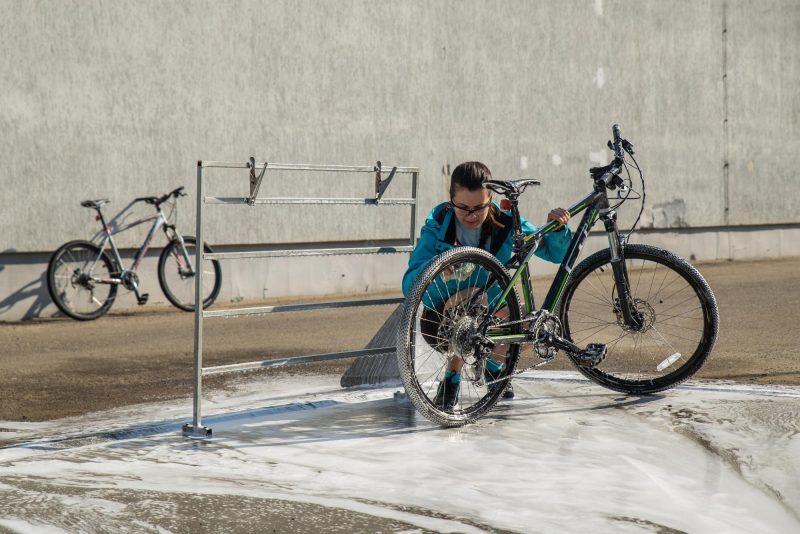 young sport woman washing bicycl