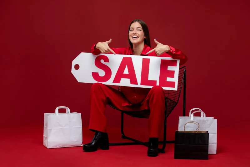 full shot woman holding sale tag